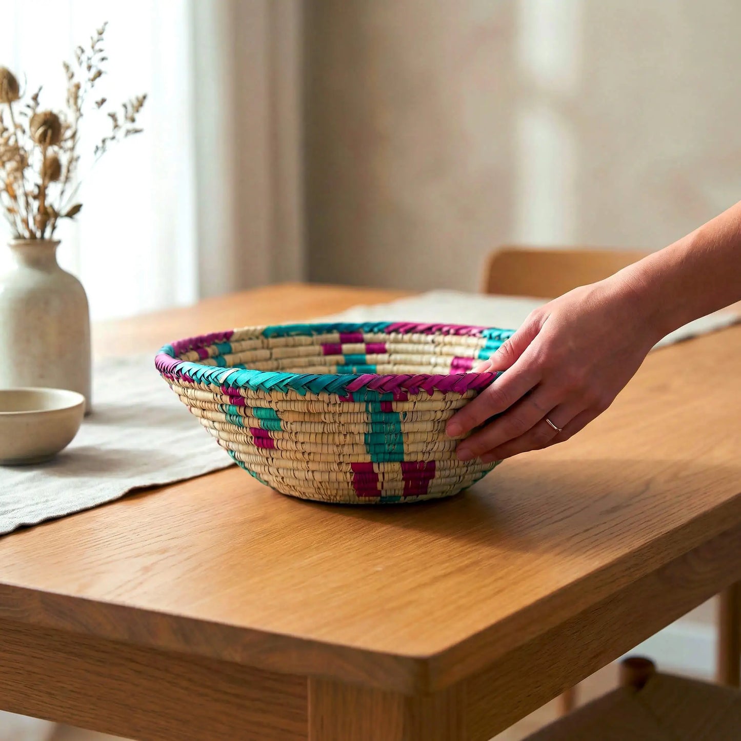The SHKOR presenting a Harvest basket, a hand-woven Mazari serving plate for bread and home decor.